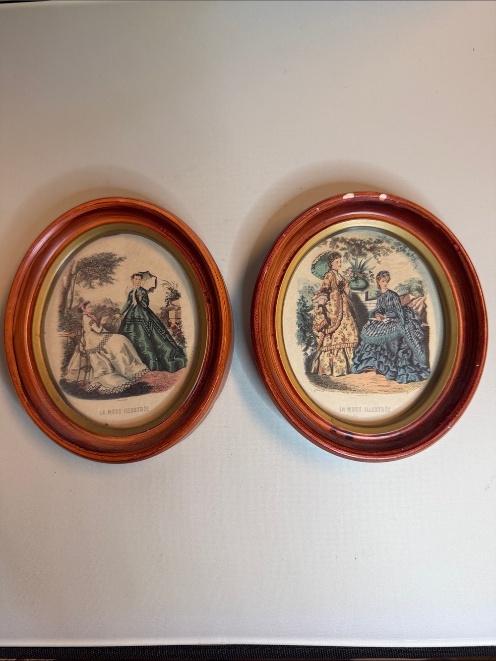 Pair of vintage 1940s La Mode Illustrèe prints in small oval frames